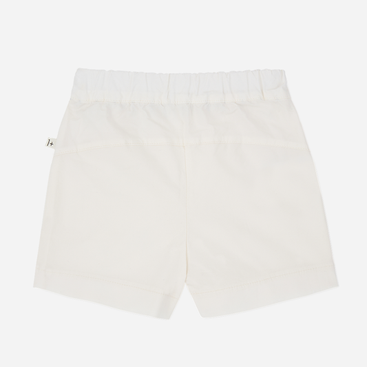 Sold at Bombon Shop, designed by 1+ in the family, off-white baby bermuda shorts with front button detail and soft cotton fabric.