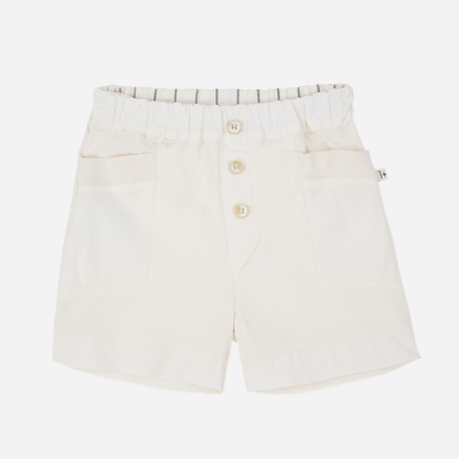 Sold at Bombon Shop, designed by 1+ in the family, off-white baby bermuda shorts with front button detail and soft cotton fabric.