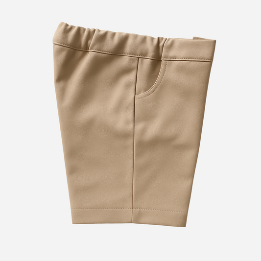 Sold at Bombon shop, designed by Paloma de la O brand, these beige Bermuda shorts for baby boys and toddlers are ideal to complete any summer or spring outfit. 