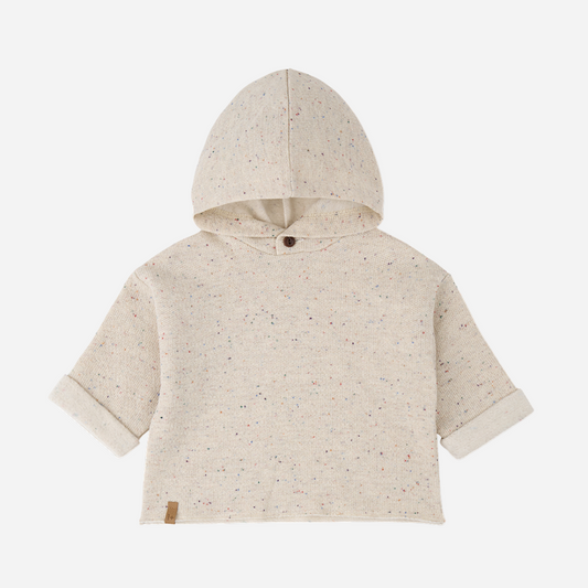 Sold at Bombon shop, designed by 1+ in the family — oatmeal-colored speckled baby hoodie with wooden button and rolled cuffs, photographed flat on white background. front