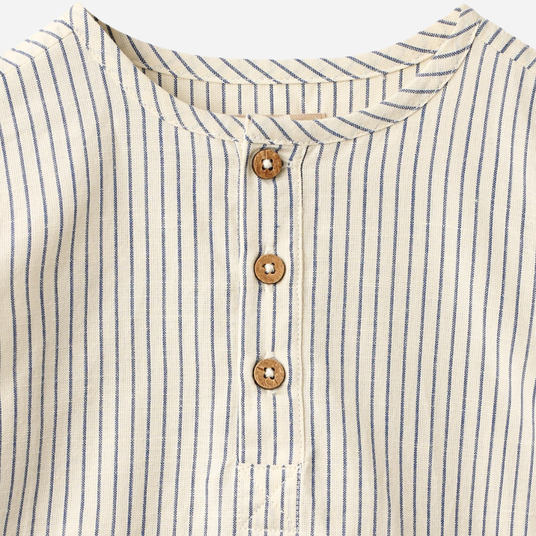 Sold at Bombon Shop, designed by Wheat, blue stripe organic cotton kids long sleeve button-down shirt with vertical blue stripes.