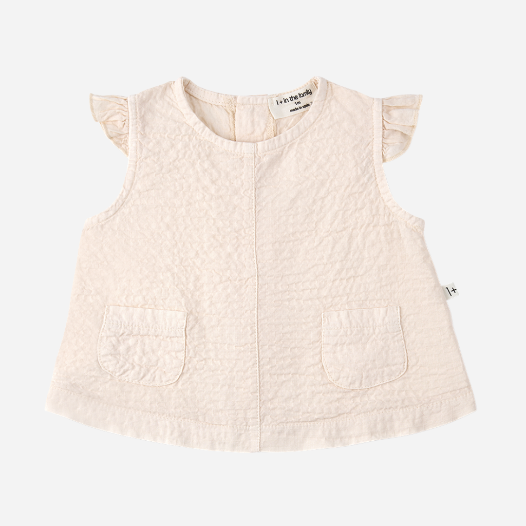 Sold at Bombon Shop, designed by 1+ in the family, blossom pink baby blouse with flutter sleeves and matching bloomers in textured cotton fabric.