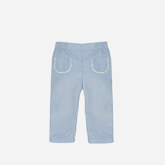 Sold at Bombon shop, designed by Fina Ejerique, a pair of sky-blue corduroy baby pants with scallop-trimmed back pockets and elastic waistband. front