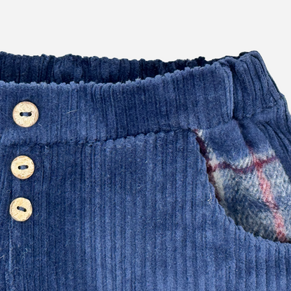 Sold at Bombon shop, designed by Tiny Soul — navy baby corduroy pants with wooden buttons and plaid-lined pockets. zoom