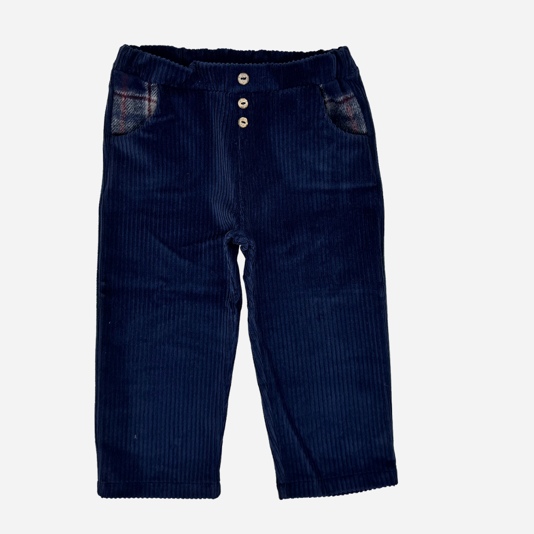 Sold at Bombon shop, designed by Tiny Soul — navy baby corduroy pants with wooden buttons and plaid-lined pockets. front