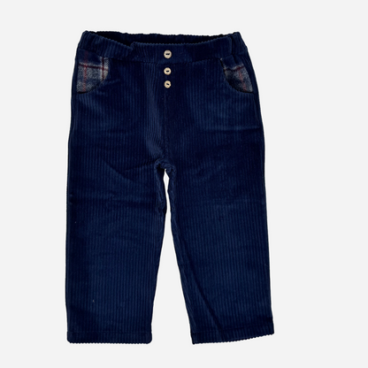 Sold at Bombon shop, designed by Tiny Soul — navy baby corduroy pants with wooden buttons and plaid-lined pockets. front