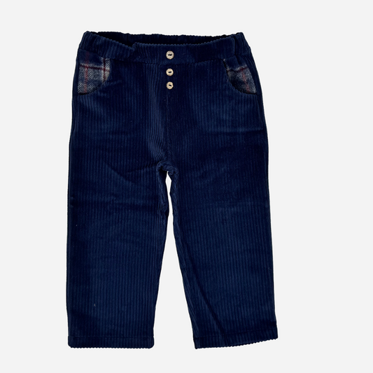 Sold at Bombon shop, designed by Tiny Soul — navy baby corduroy pants with wooden buttons and plaid-lined pockets. front