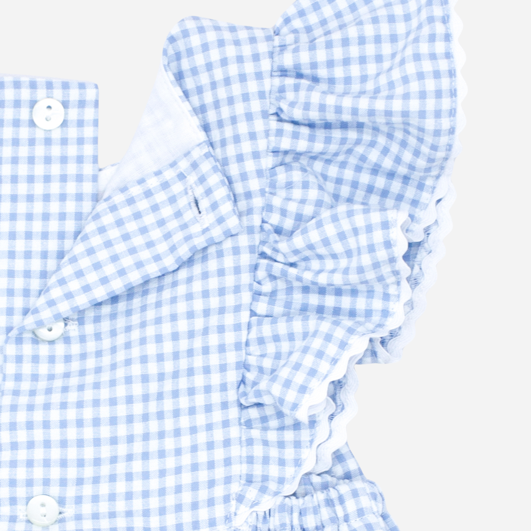 Sold in Bombon shop, designed by Fina Ejerique brand a gingham blue ruffle baby romper ideal for spring and summer. Zoom view