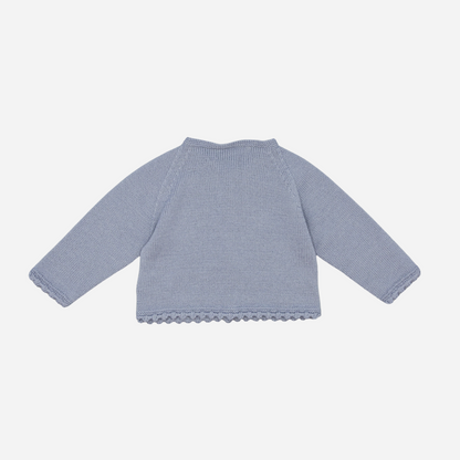Sold at Bombon shop, designed by Fina Ejerique, a powder-blue knit baby cardigan with scalloped trim and front buttons. back