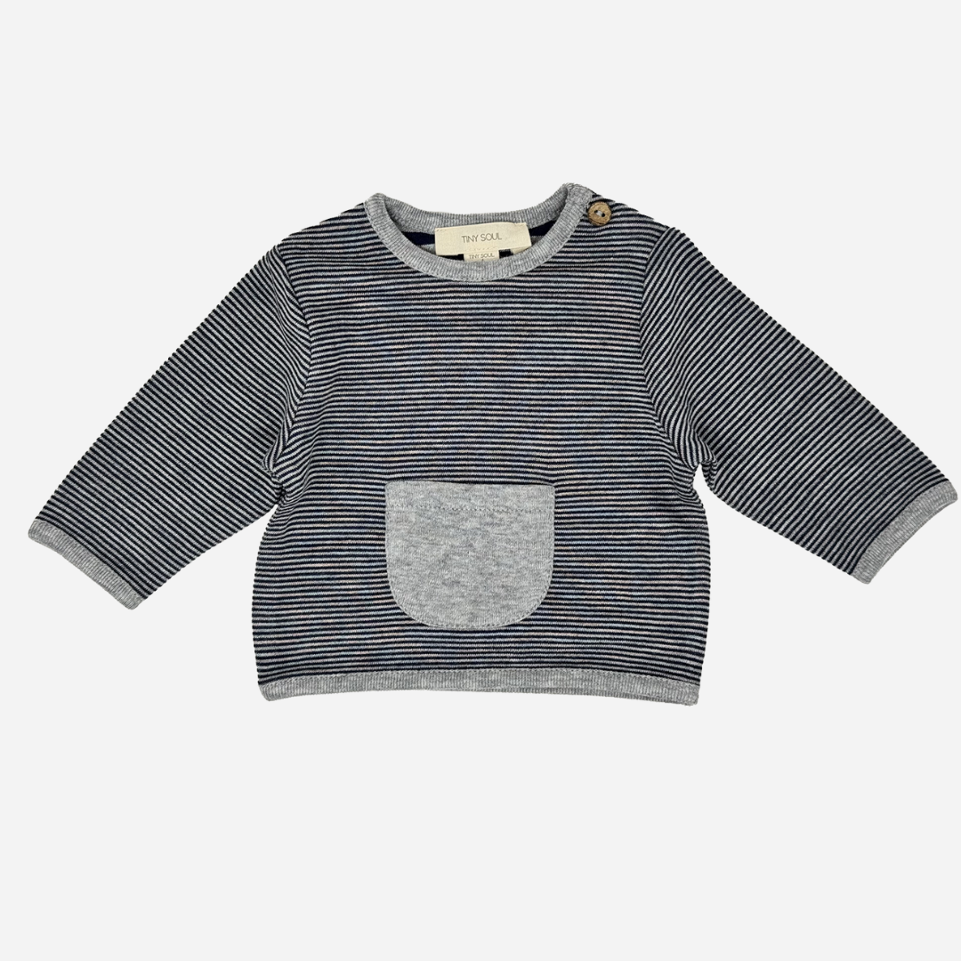 Sold at Bombon shop, designed by Tiny Soul — navy and ivory striped baby shirt with shoulder button and grey front pocket. front