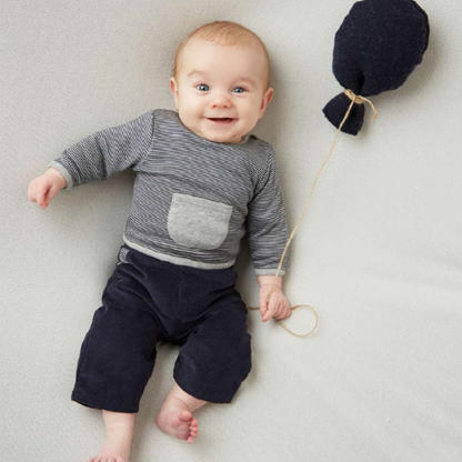 Sold at Bombon shop, designed by Tiny Soul — navy and ivory striped baby shirt with shoulder button and grey front pocket. model