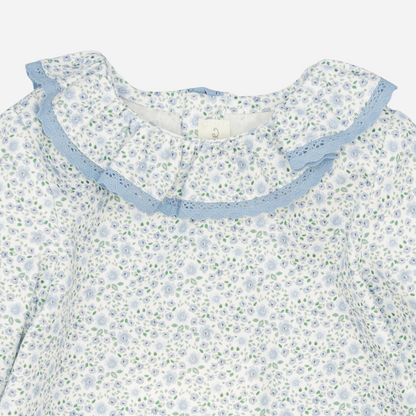 Sold at Bombon shop, designed by Fina Ejerique, a white floral viyella blouse with blue lace ruffle collar and long sleeves, styled to pair with matching blue corduroy bottoms. zoom
