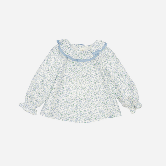 Sold at Bombon shop, designed by Fina Ejerique, a white floral viyella blouse with blue lace ruffle collar and long sleeves, styled to pair with matching blue corduroy bottoms. front