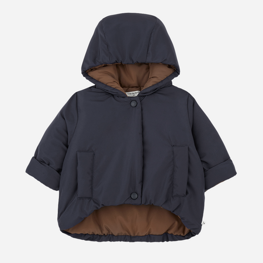 Sold at Bombon shop, designed by 1+ in the family — navy baby puffer jacket with brown lining, hood, front snaps, and patch pockets, laid flat on white backgroud. front