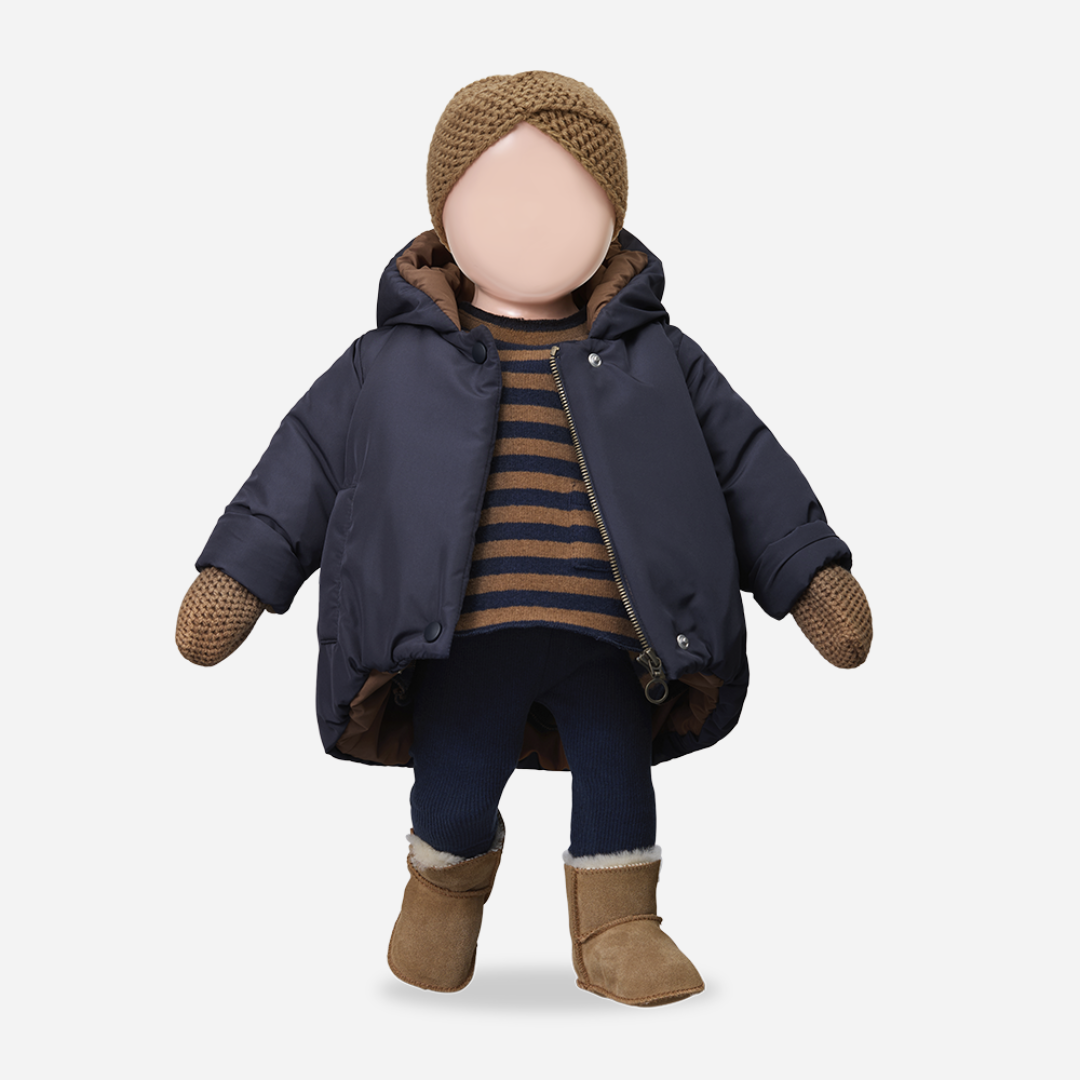 Sold at Bombon shop, designed by 1+ in the family — navy baby puffer jacket with brown lining, hood, front snaps, and patch pockets, laid flat on white background. manequin