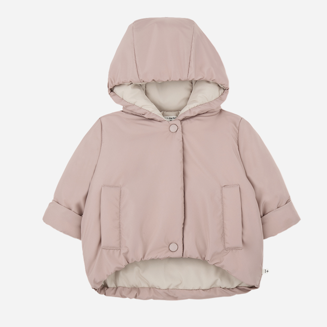 Sold at Bombon shop, designed by 1+ in the family — nude pink baby puffer jacket with cream lining, hood, snap closures, and front patch pockets, laid flat on white background. front
