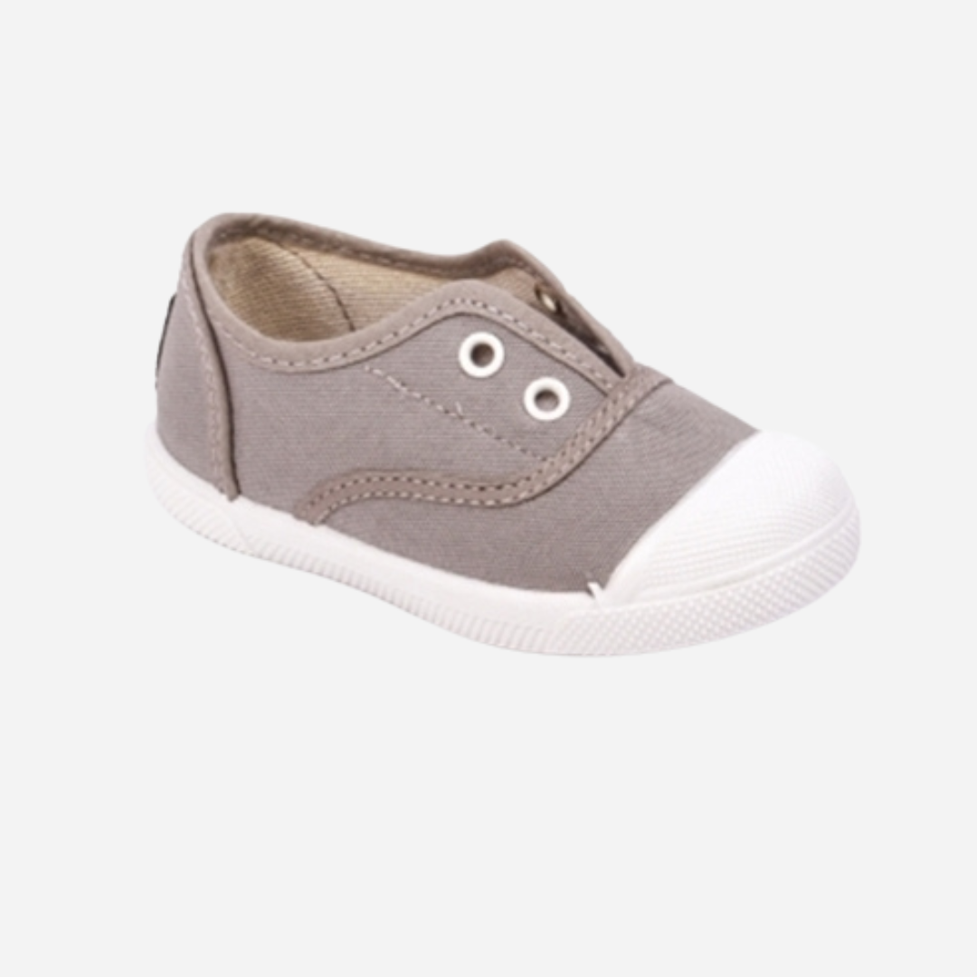 sold at Bombon shop. These canvas slip on sneakers in gray are designed for play and everyday wear with a white toecap and elasticated inner, without laces. 