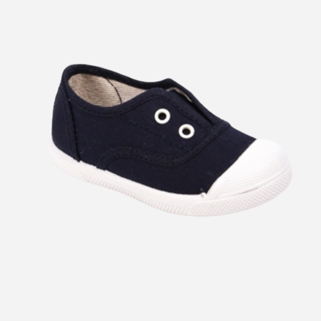 sold at Bombon shop. These canvas slip on sneakers in navy are designed for play and everyday wear with a white toecap and elasticated inner, without laces. 