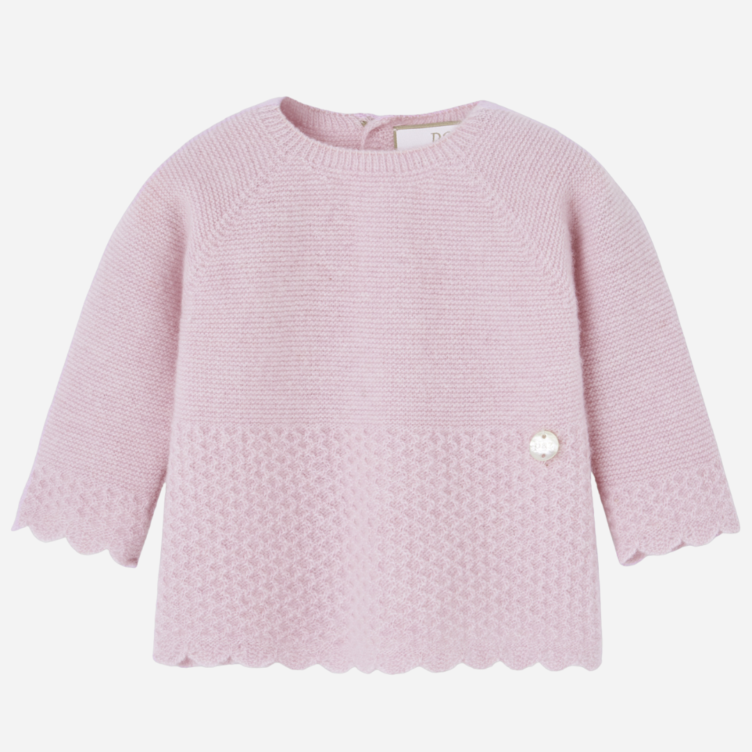 Sold at Bombon shop, designed by Paz Rodriguez, light pink knit baby top with scalloped hem and textured lower half.