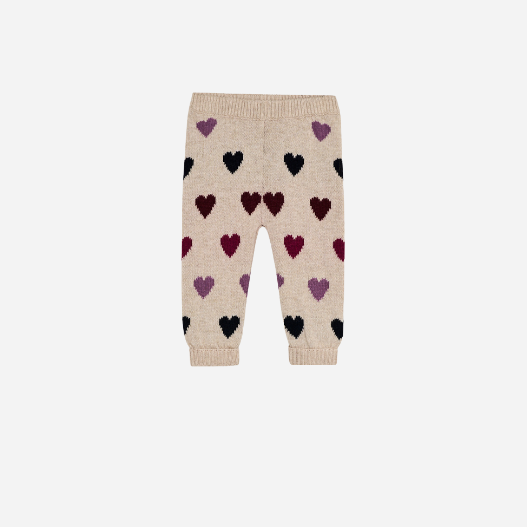 Sold at Bombon Shop, these baby girl knit pants by The New Society come in a soft beige hue with an allover multicolor heart pattern and ribbed trims. front