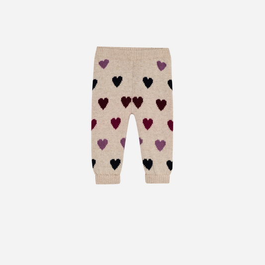 Sold at Bombon Shop, these baby girl knit pants by The New Society come in a soft beige hue with an allover multicolor heart pattern and ribbed trims. front
