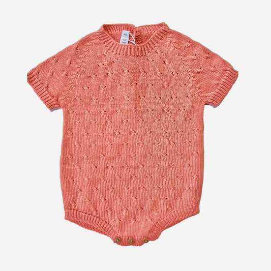 sold at Bombon shop, designed by Paloma de la O brand, this coral knit romper for baby boys is ideal for spring and summer. front view
