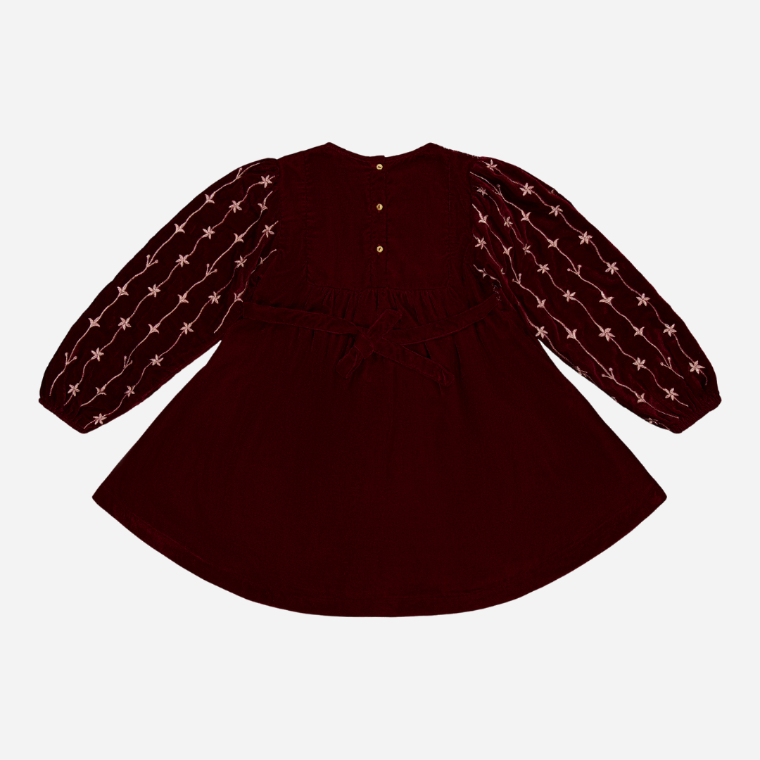 sold at Bombon shop, designed by Bachaa Paris, Dress, Velvet in Burgundy color, Plain lining in organic cotton voile, Fully hand embroidered sleeves with a golden thread, Smocked front, Gathered at the front and back, Golden buttons at the back. back view