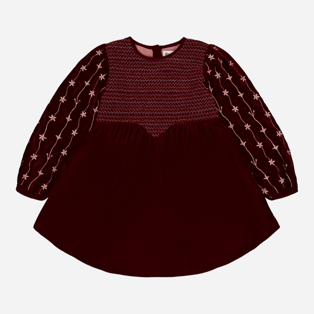 sold at Bombon shop, designed by Bachaa Paris, Dress, Velvet in Burgundy color, Plain lining in organic cotton voile, Fully hand embroidered sleeves with a golden thread, Smocked front, Gathered at the front and back, Golden buttons at the back. front view