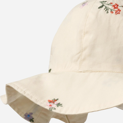 Sold at Bombon Shop, designed by Wheat, ivory organic cotton sun hat with delicate embroidered flowers and wide brim with tie detail.