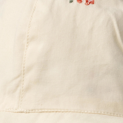 Sold at Bombon Shop, designed by Wheat, ivory organic cotton sun hat with delicate embroidered flowers and wide brim with tie detail.