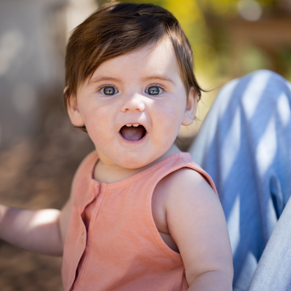 Sold at Bombon shop, designed by 1+ in the family brand, this coral jumpsuit for baby girls and toddlers is perfect for spring and summer. model view