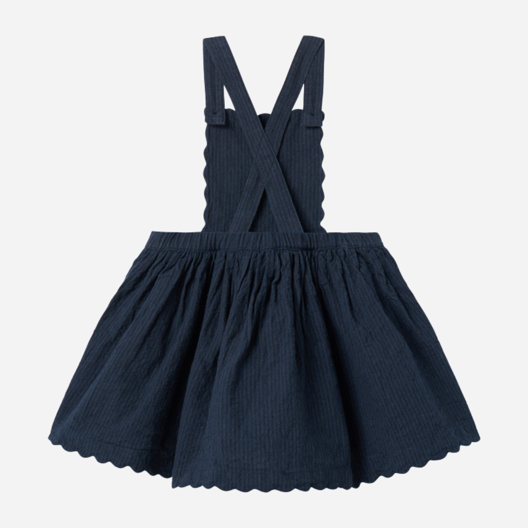 Sold at Bombon shop, designed by MarMar Copenhagen — navy 100% cotton textured pinafore dress with scalloped edges, pairs perfectly with the cream blouse.