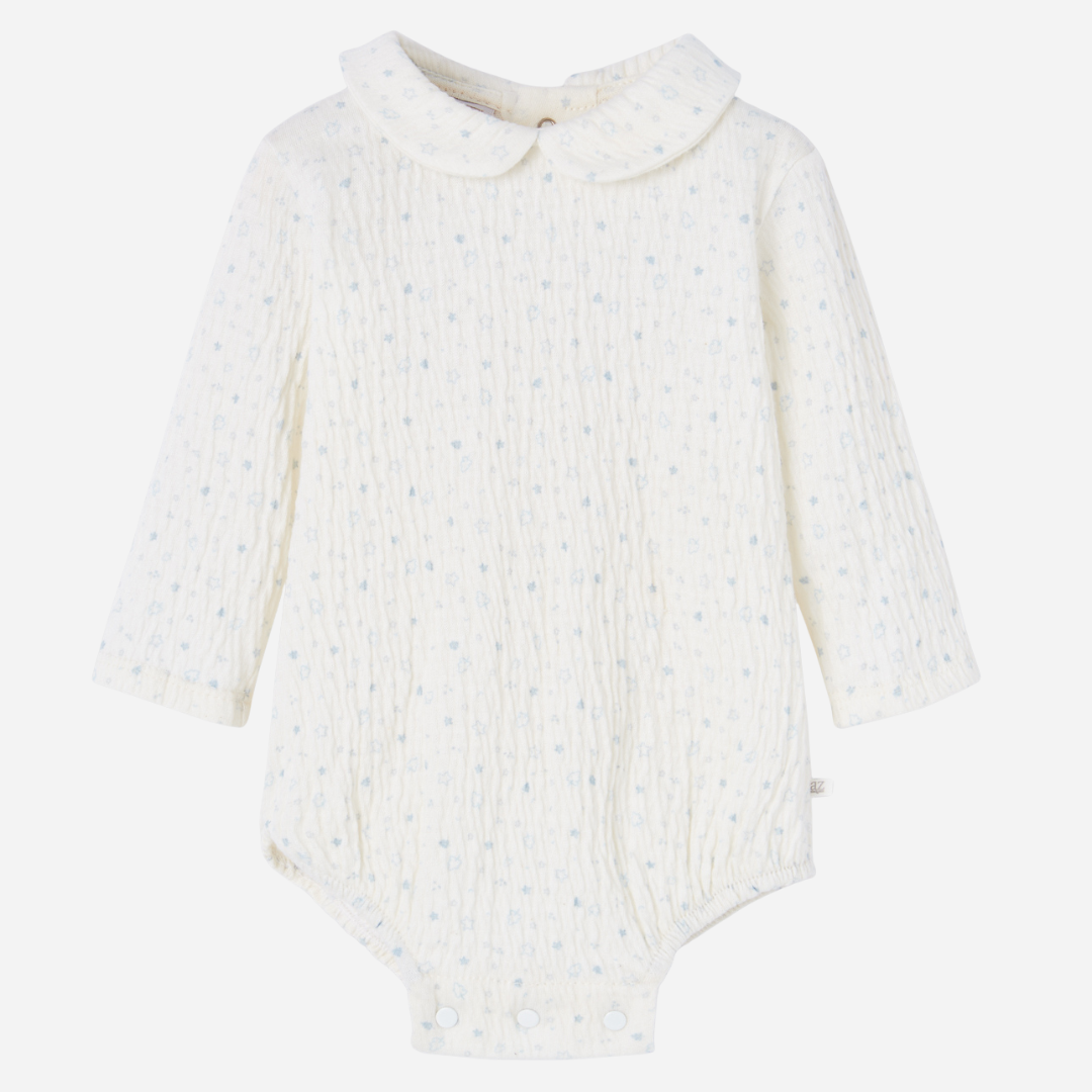 Sold at Bombon shop, designed by Paz Rodriguez, ivory baby bodysuit with blue star print and Peter Pan collar.