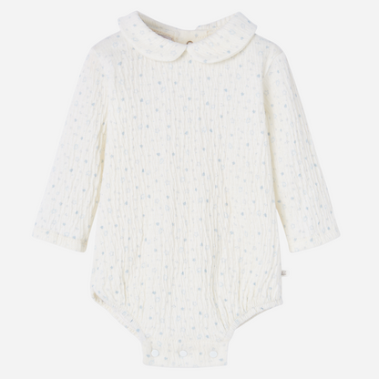 Sold at Bombon shop, designed by Paz Rodriguez, ivory baby bodysuit with blue star print and Peter Pan collar.
