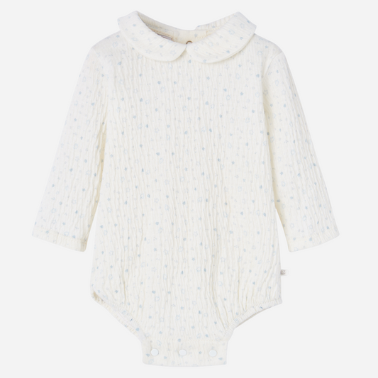 Sold at Bombon shop, designed by Paz Rodriguez, ivory baby bodysuit with blue star print and Peter Pan collar.