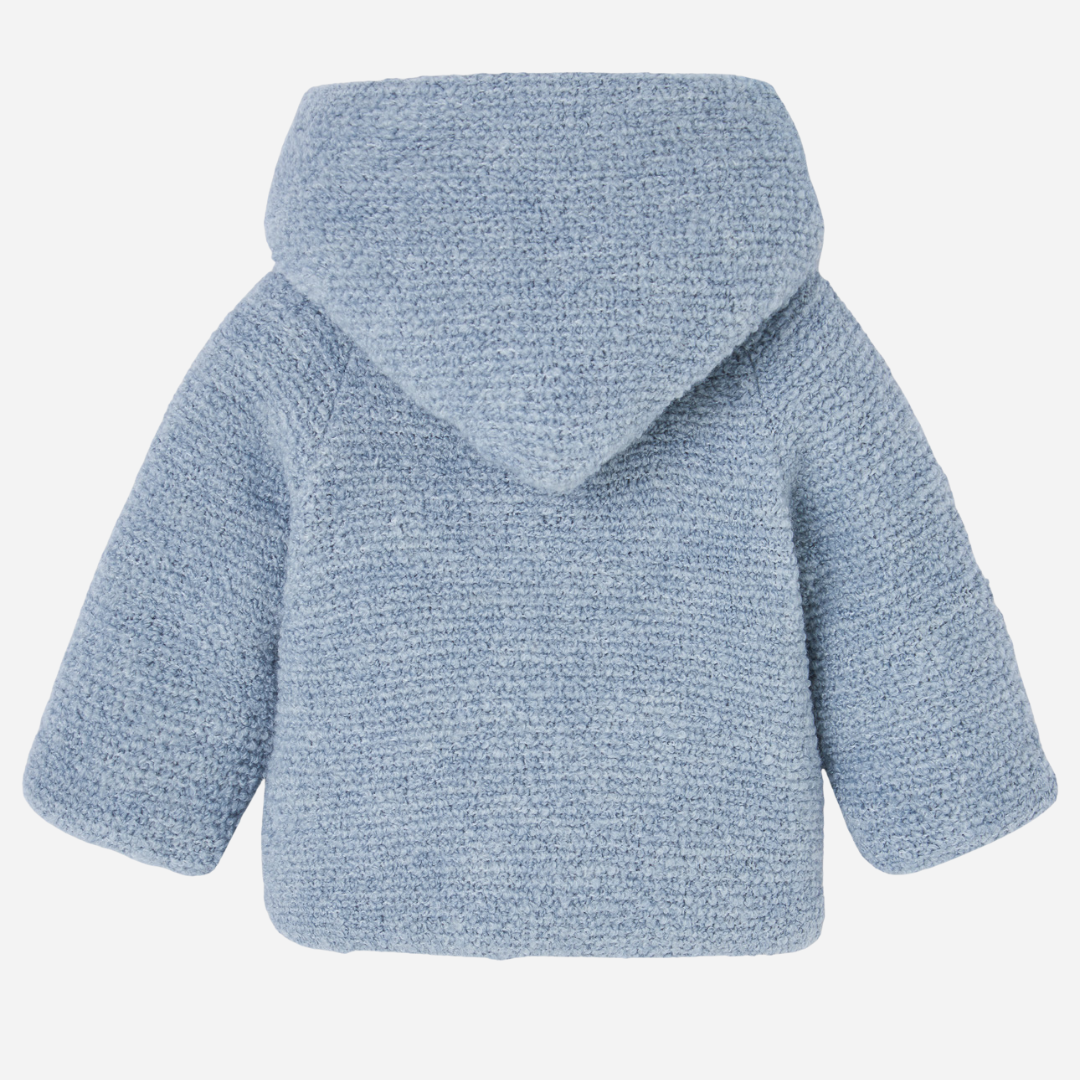 Sold at Bombon shop, designed by Paz Rodriguez, baby blue hooded coat with textured knit and white lining.