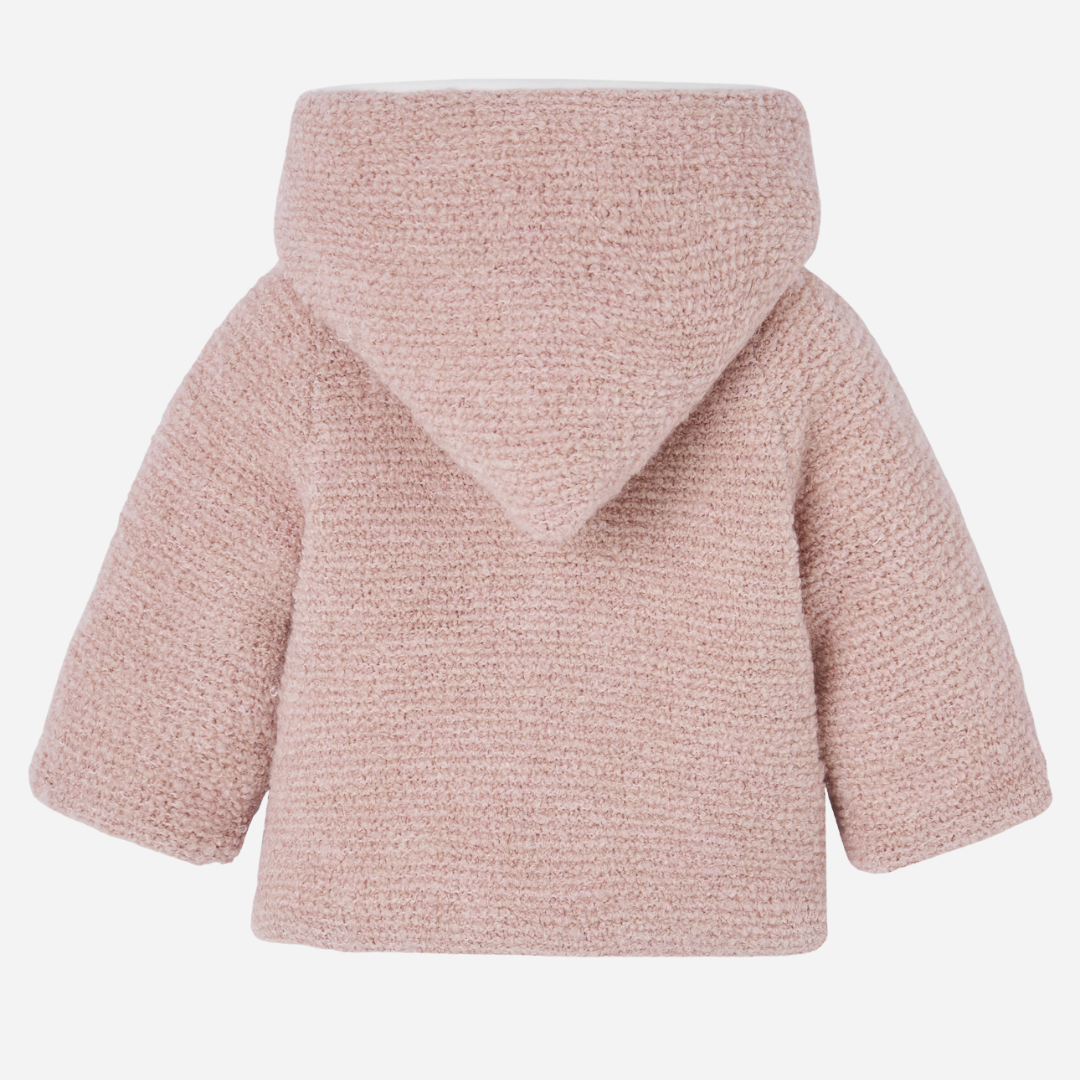 Sold at Bombon shop, designed by Paz Rodriguez, baby pink hooded coat with soft boucle texture and double-breasted front.