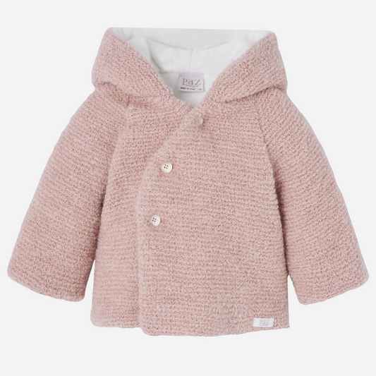 Sold at Bombon shop, designed by Paz Rodriguez, baby pink hooded coat with soft boucle texture and double-breasted front.