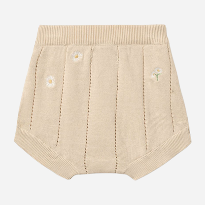 Sold at Bombon Shop, designed by Wheat, sandshell white flowers organic cotton knitted baby shorts with elastic waistband and subtle floral knit details.