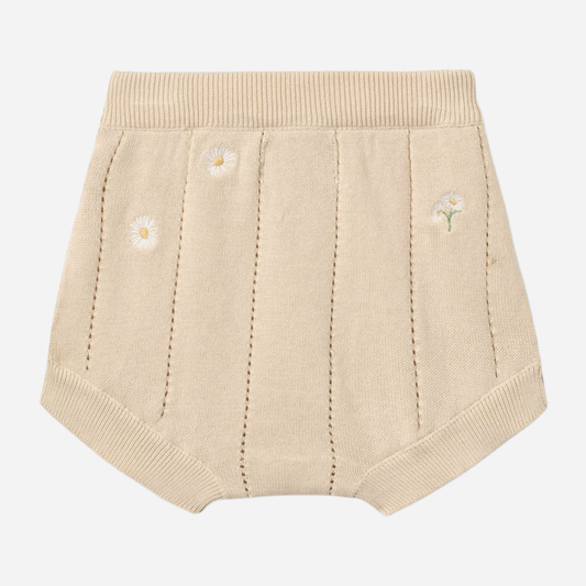 Sold at Bombon Shop, designed by Wheat, sandshell white flowers organic cotton knitted baby shorts with elastic waistband and subtle floral knit details.