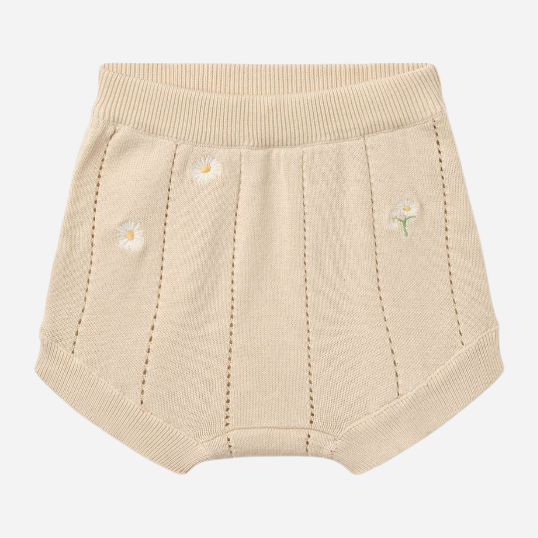 Sold at Bombon Shop, designed by Wheat, sandshell white flowers organic cotton knitted baby shorts with elastic waistband and subtle floral knit details.