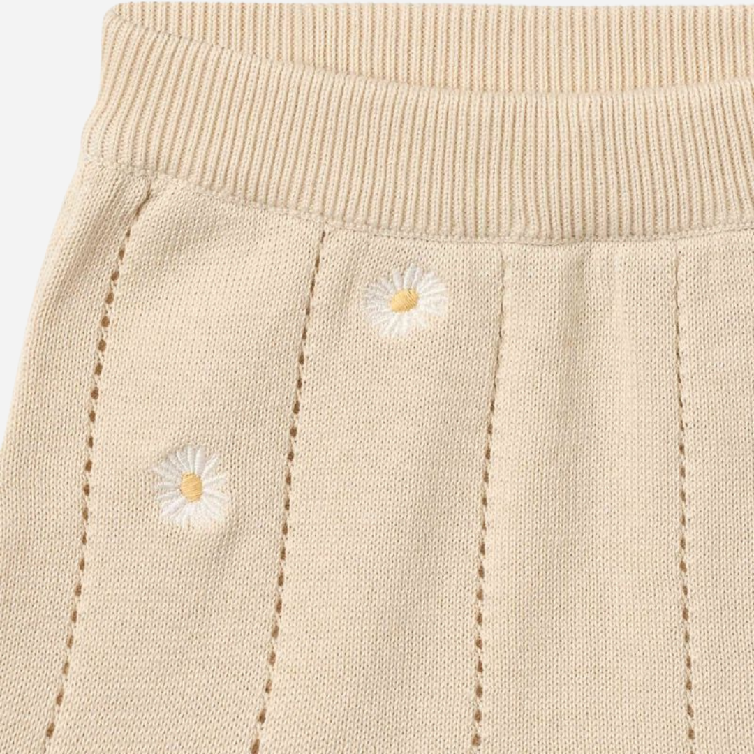 Sold at Bombon Shop, designed by Wheat, sandshell white flowers organic cotton knitted baby shorts with elastic waistband and subtle floral knit details.