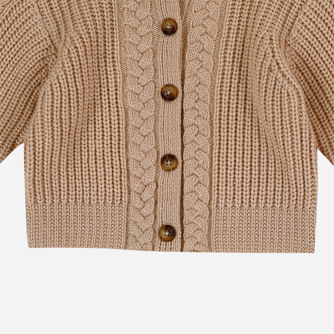 Sold at Bombon shop, designed by Donsje from Amsterdam, this baby and toddler girl cardigan in beige with a braid detail is the perfect pre-fall and transition piece.  bottom view