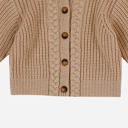 Sold at Bombon shop, designed by Donsje from Amsterdam, this baby and toddler girl cardigan in beige with a braid detail is the perfect pre-fall and transition piece.  bottom view
