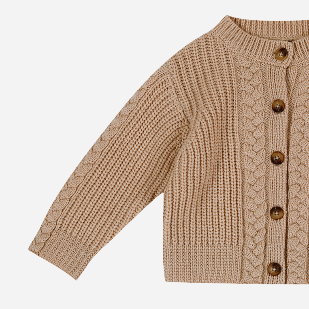 Sold at Bombon shop, designed by Donsje from Amsterdam, this baby and toddler girl cardigan in beige with a braid detail is the perfect pre-fall and transition piece. side view