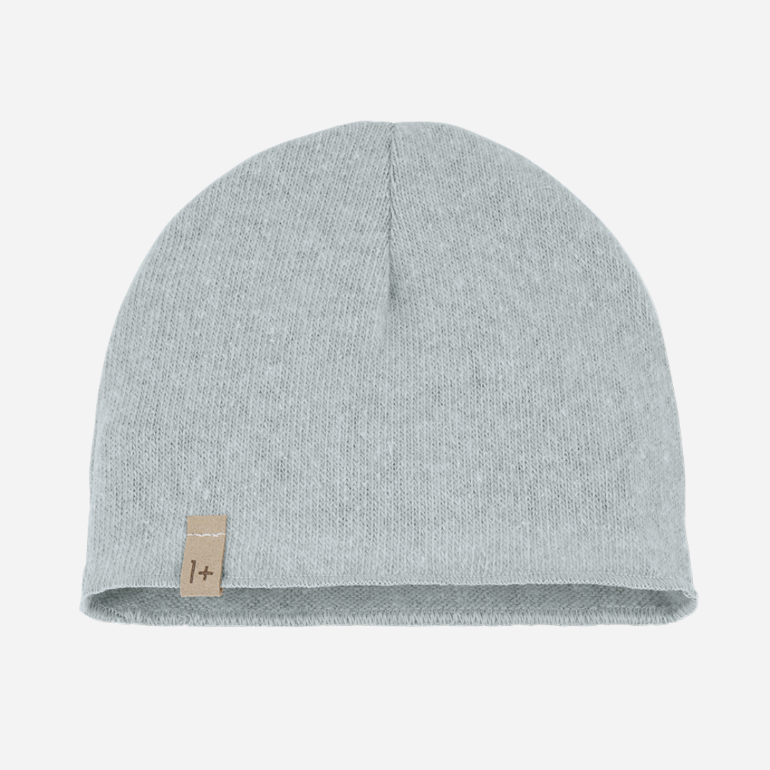 The Elise Beanie in Nuvola by 1+ in the family is a cozy winter staple with an airy, cloud-like hue. Crafted in Spain from a soft cotton blend, it offers just the right amount of warmth while maintaining a clean, minimalist look. This versatile beanie effortlessly complements the Nuvola pants or matching pieces from the same collection — perfect for stylish, layered looks all season long. front