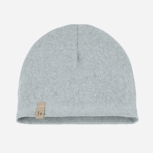 The Elise Beanie in Nuvola by 1+ in the family is a cozy winter staple with an airy, cloud-like hue. Crafted in Spain from a soft cotton blend, it offers just the right amount of warmth while maintaining a clean, minimalist look. This versatile beanie effortlessly complements the Nuvola pants or matching pieces from the same collection — perfect for stylish, layered looks all season long. front