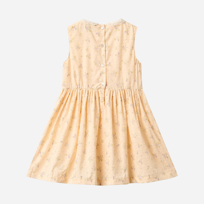 Sold at Bombon Shop, designed by Wheat, barely apricot flowers organic cotton sleeveless dress with soft gathered skirt.