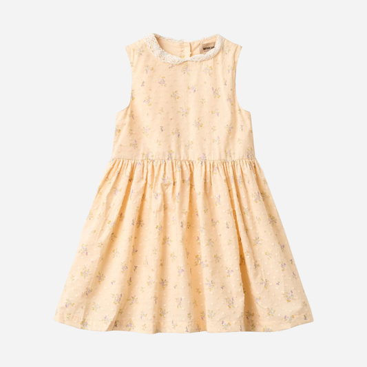 Sold at Bombon Shop, designed by Wheat, barely apricot flowers organic cotton sleeveless dress with soft gathered skirt.
