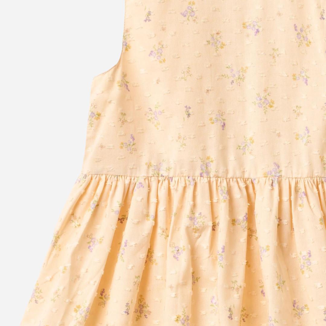 Sold at Bombon Shop, designed by Wheat, barely apricot flowers organic cotton sleeveless dress with soft gathered skirt.